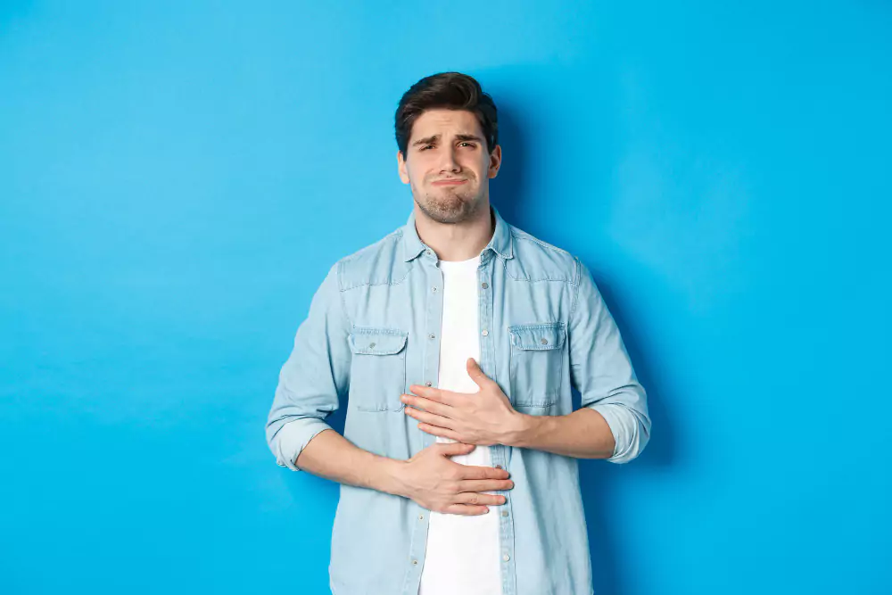 Blue Shirt Man Experiencing Vomiting Symptom