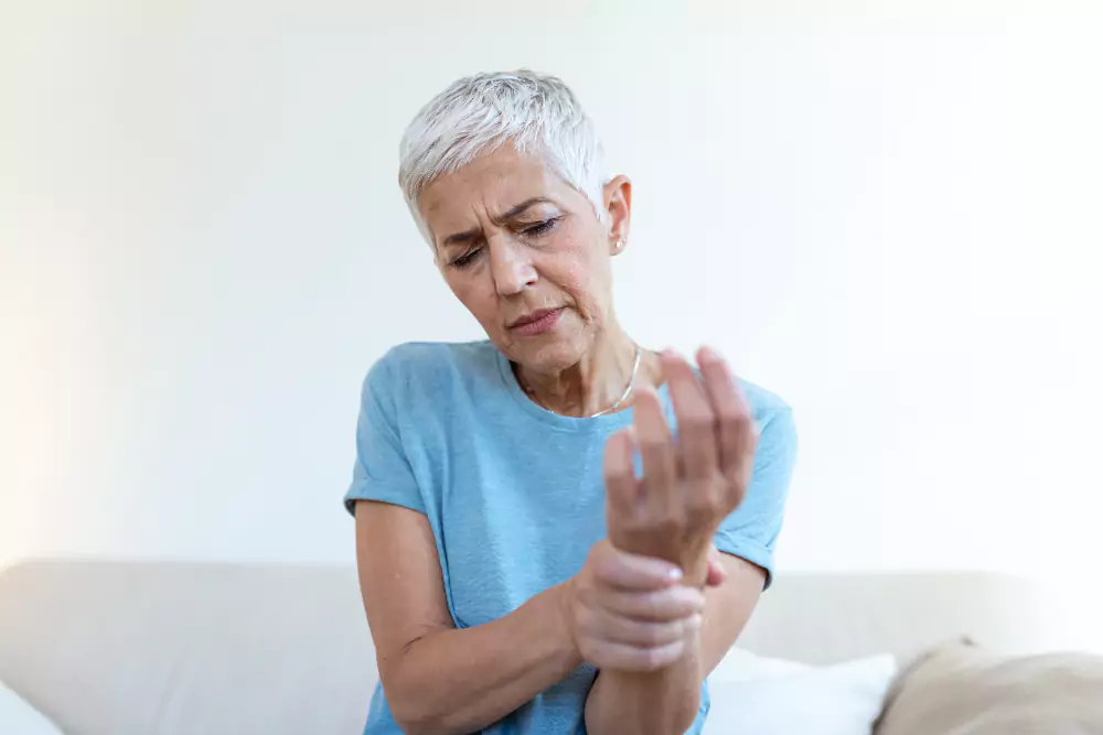 Elderly Woman Suffering From Pain In Hand Arthritis